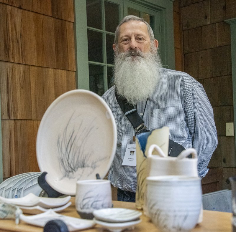 Lewes ceramic artist Jeff Watson poses with his hand-painted ceramics, featuring simple images of nature.